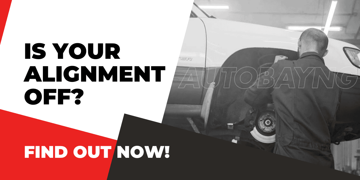 Car mechanic inspecting wheel alignment with tools, highlighting the importance of checking vehicle alignment