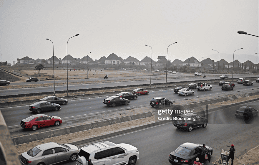 Vehicles travel along Kubwa expressway in Abuja, Nigeria which indicates they may have respective valid their driver's license at hand